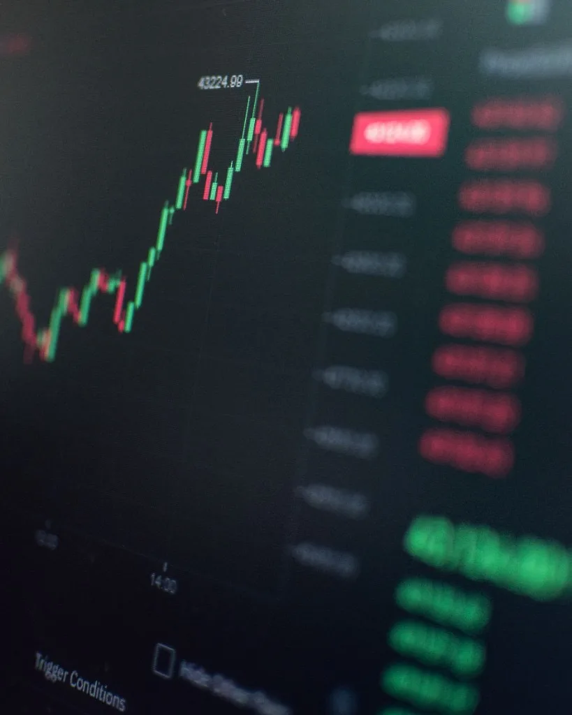 Close-up of a dark trading screen showing a red and green candlestick chart with order-book data on the right
